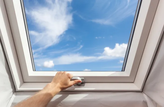 a hand opening a skylight