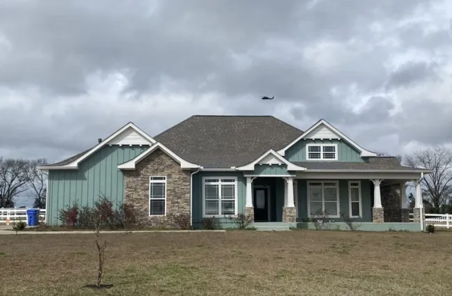 a house with a helicopter flying over it