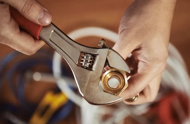 a plumber fixing a broken pipe in atlanta