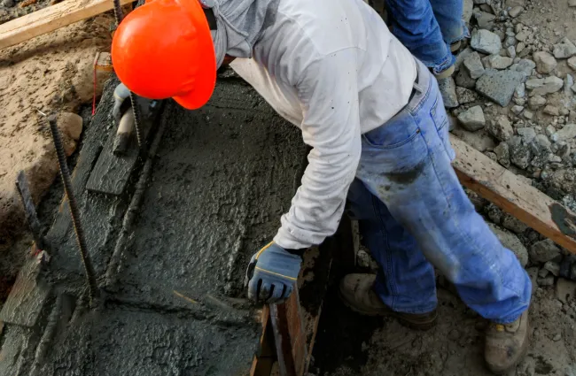 men wearing hard hats and working on a construction site