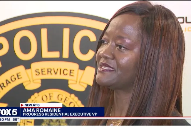 Female executive speaking at a police department event with a FOX 5 news lower third graphic