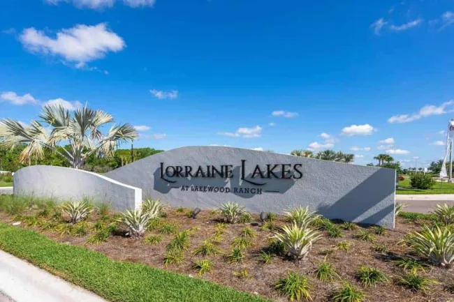 Entrance sign for Lorraine Lakes at Lakewood Ranch with landscaping under a blue sky.