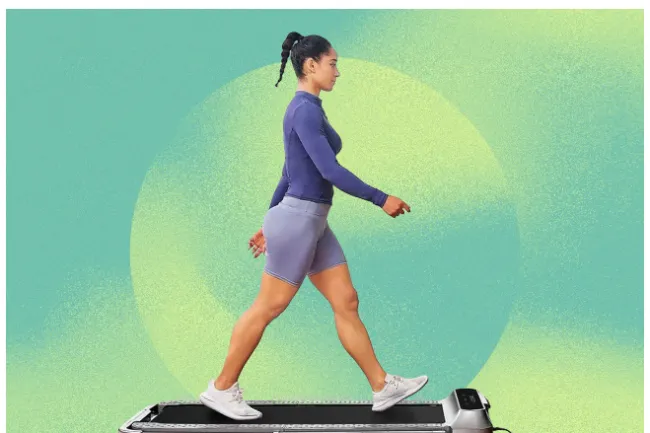 Woman walking on a sleek treadmill designed for home workouts and walking breaks, wearing activewear.