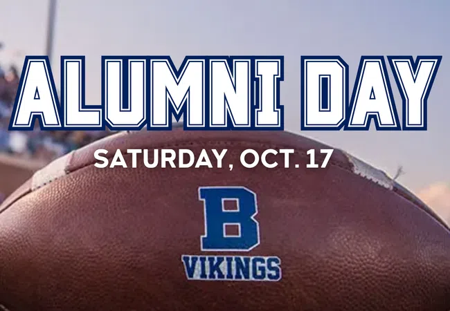 Close-up of a football with a blue B Vikings logo and Alumni Day text for Saturday, Oct. 17 at a stadium.