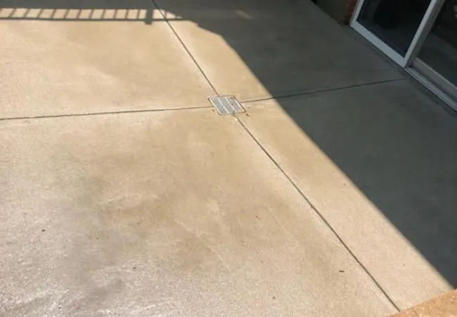 a small square object on a stone surface next to a window