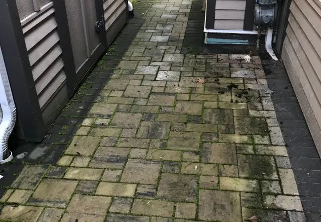 a stone walkway between two buildings