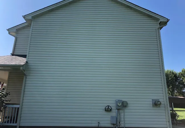 a grey building with a white roof