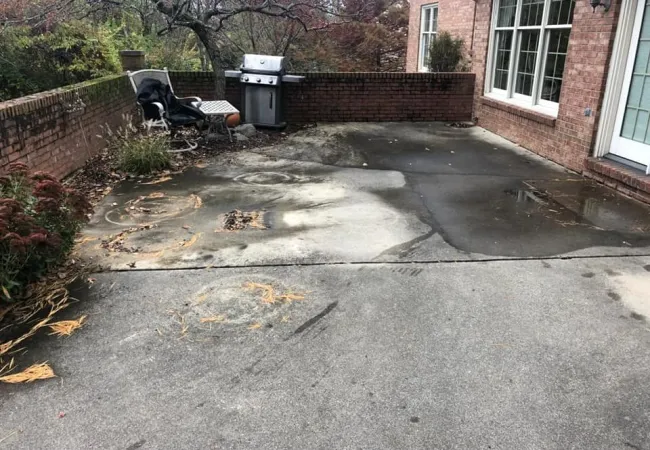 a chair and a trash can on a sidewalk