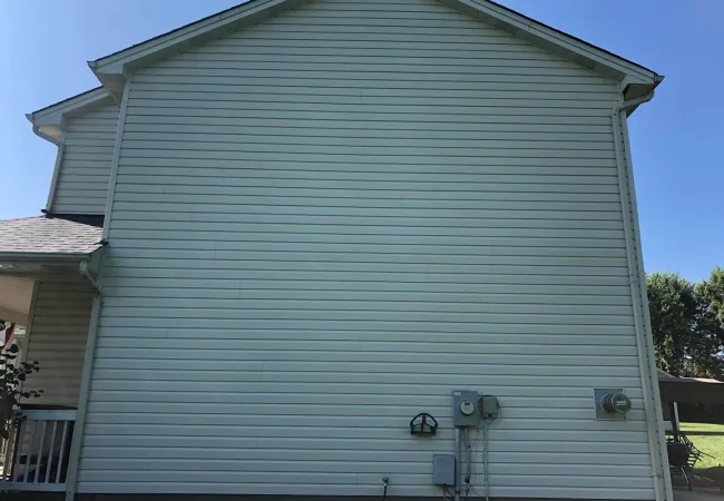 a grey building with a white roof