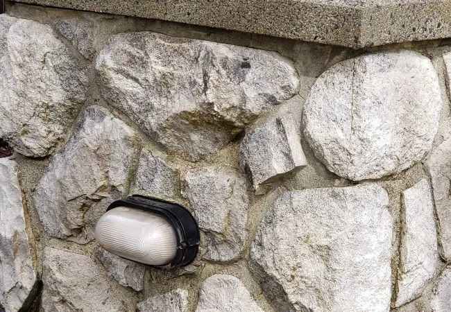 a stone wall with a round hole in it