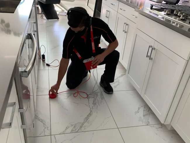 a man wearing headphones and sitting on a white floor