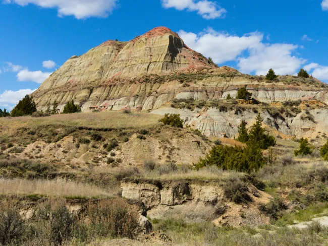 a rocky mountain with a blue sky