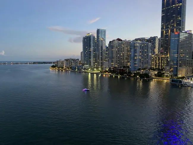 a city skyline with a body of water in front of it