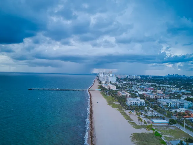 a beach with buildings and water