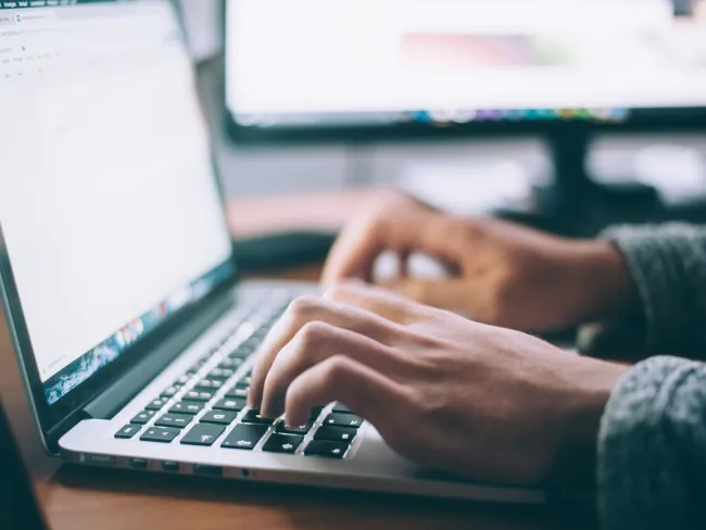 a person typing on a laptop