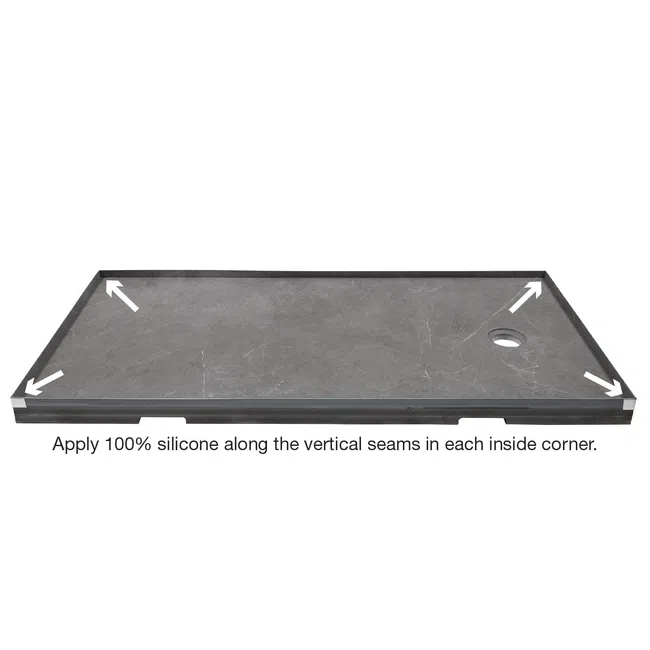 Rectangular gray shower base with raised edges and arrows pointing to inside corners for silicone sealing.