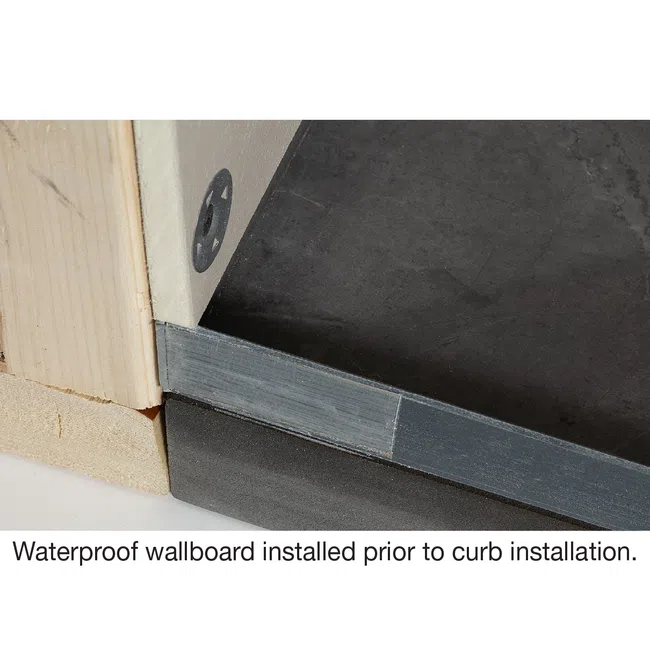Close-up of waterproof wallboard installed on a floor corner before curb installation in construction.