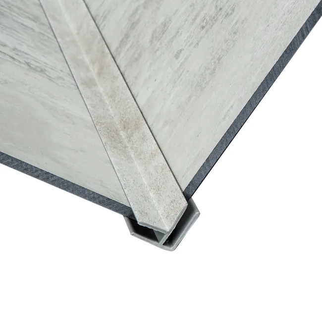 Close-up of metal corner joint connecting two structural panels with a reinforcing metal brace on a white background.