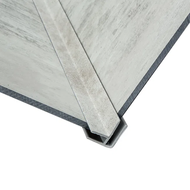 Close-up of metal corner protector for panels showing protective edge and textured surface.