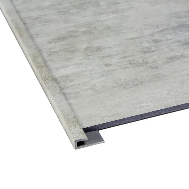 Close-up of a gray laminate flooring edge with a matching metal extrusion trim attached.