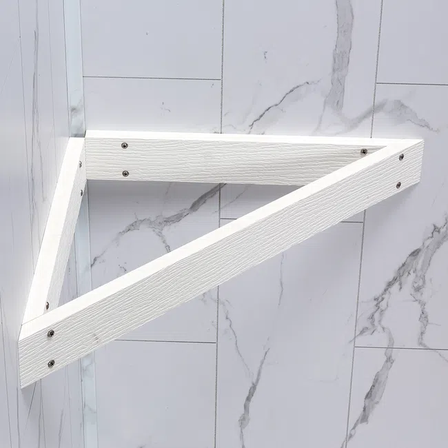 White triangular wooden shelf bracket mounted on a marble-patterned wall with screws.