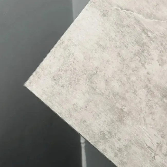 Close-up of a textured light gray tile with subtle patterns against a dark matte background.