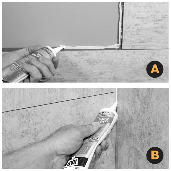 Applying white sealant in tile gaps on walls and floor to fill and waterproof joints with a caulking gun.