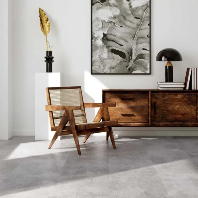 Modern interior with wooden chair, sideboard, black lamp, abstract leaf painting, and decorative gold leaf on pedestal