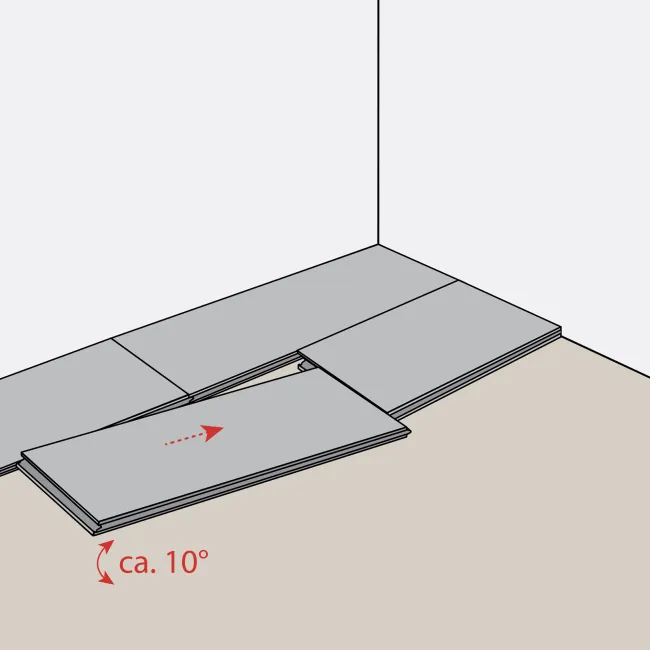 Illustration of flooring panels being installed with one panel tilted at approximately 10 degrees for fitting.