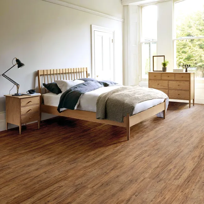 Bright bedroom with wooden floor, modern wooden bed, nightstand, dresser, and large windows with natural light.