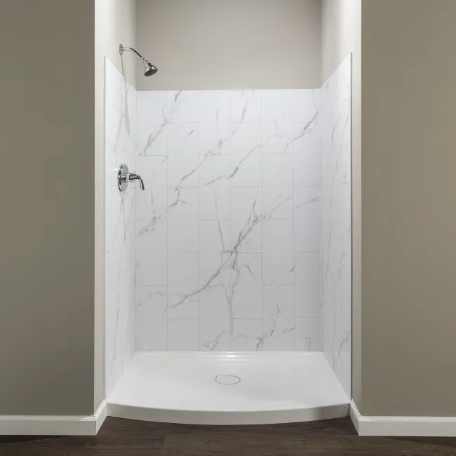 Minimalist white marble tile shower with chrome fixtures and dark wood flooring in a modern bathroom.