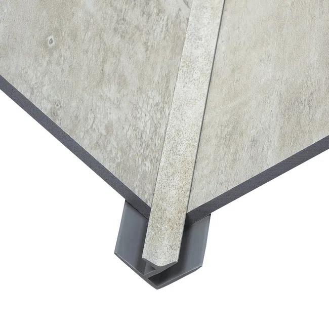 Corner of textured tile panels joined with a gray plastic corner trim piece on a white background
