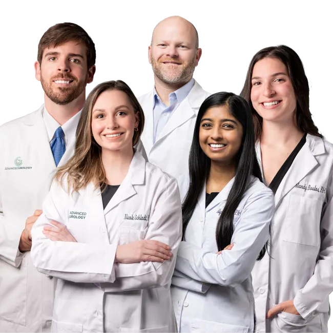 Diverse group of five medical professionals wearing white lab coats smiling and standing together.