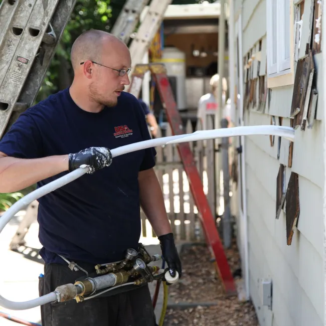 a person holding a hose