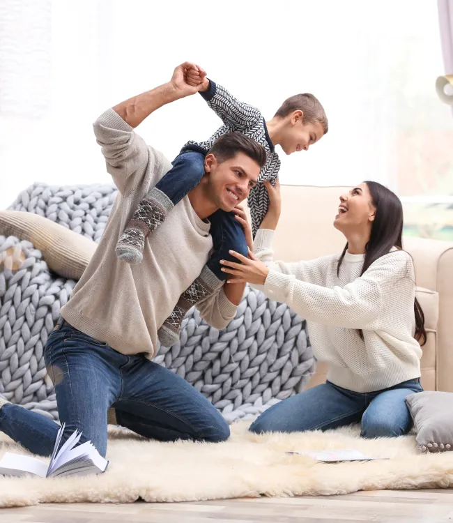 a person holding a person's waist while sitting on a couch