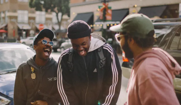 a group of men standing on a sidewalk
