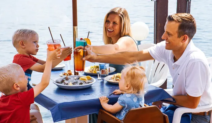 a group of people sitting at a table eating food