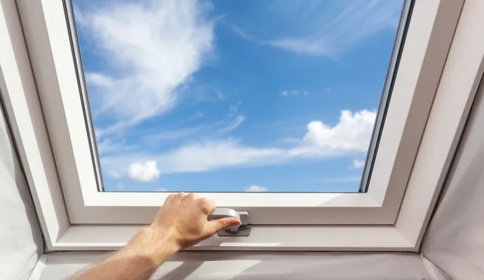 a hand opening a skylight