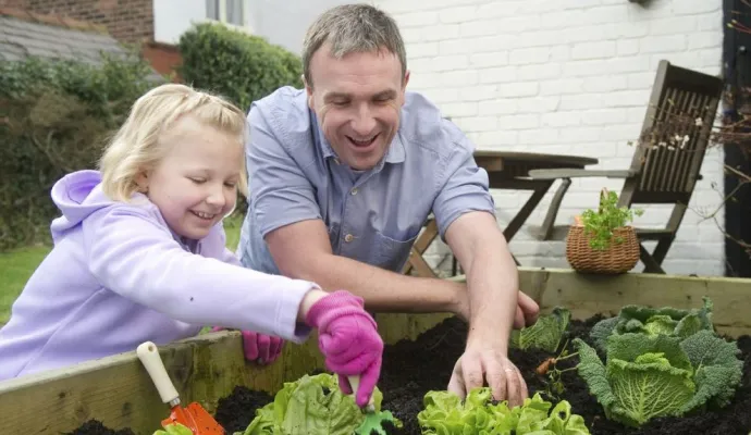 a person and a child in a garden