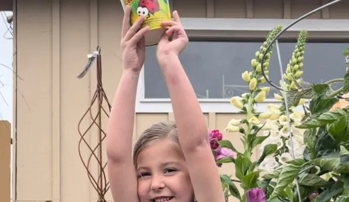 a child holding a ladybug cup