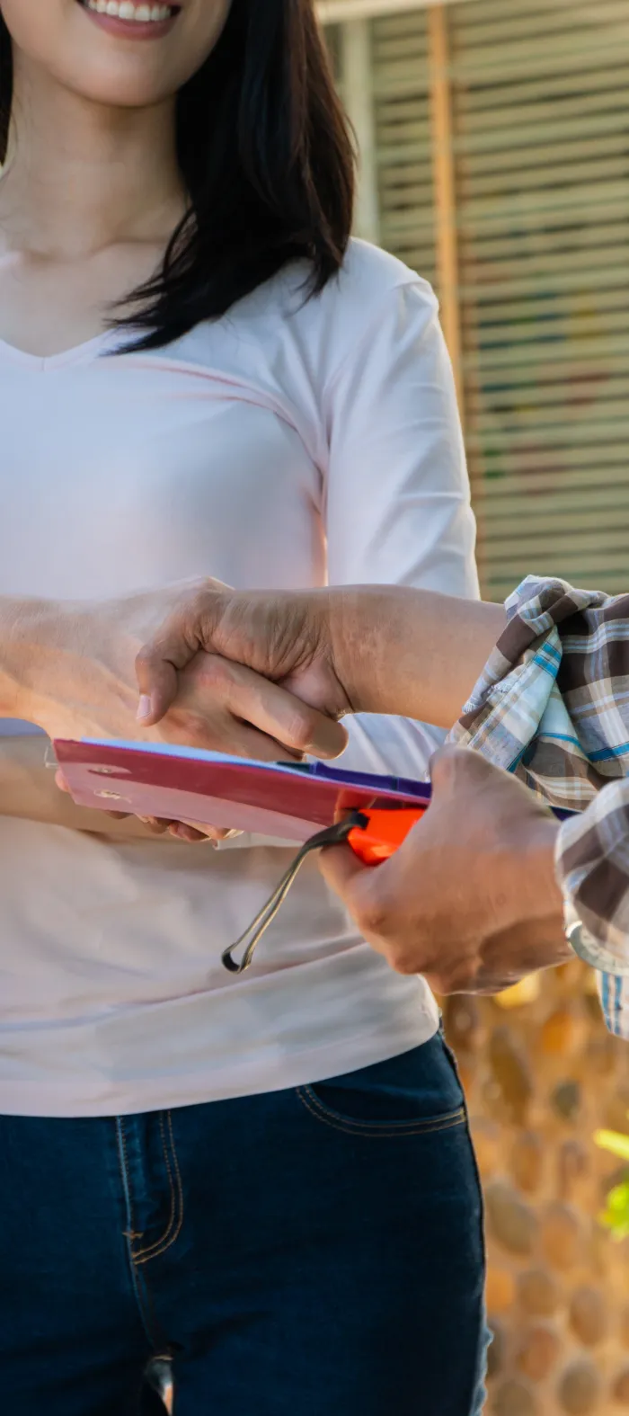 a group of people holding a red tablet