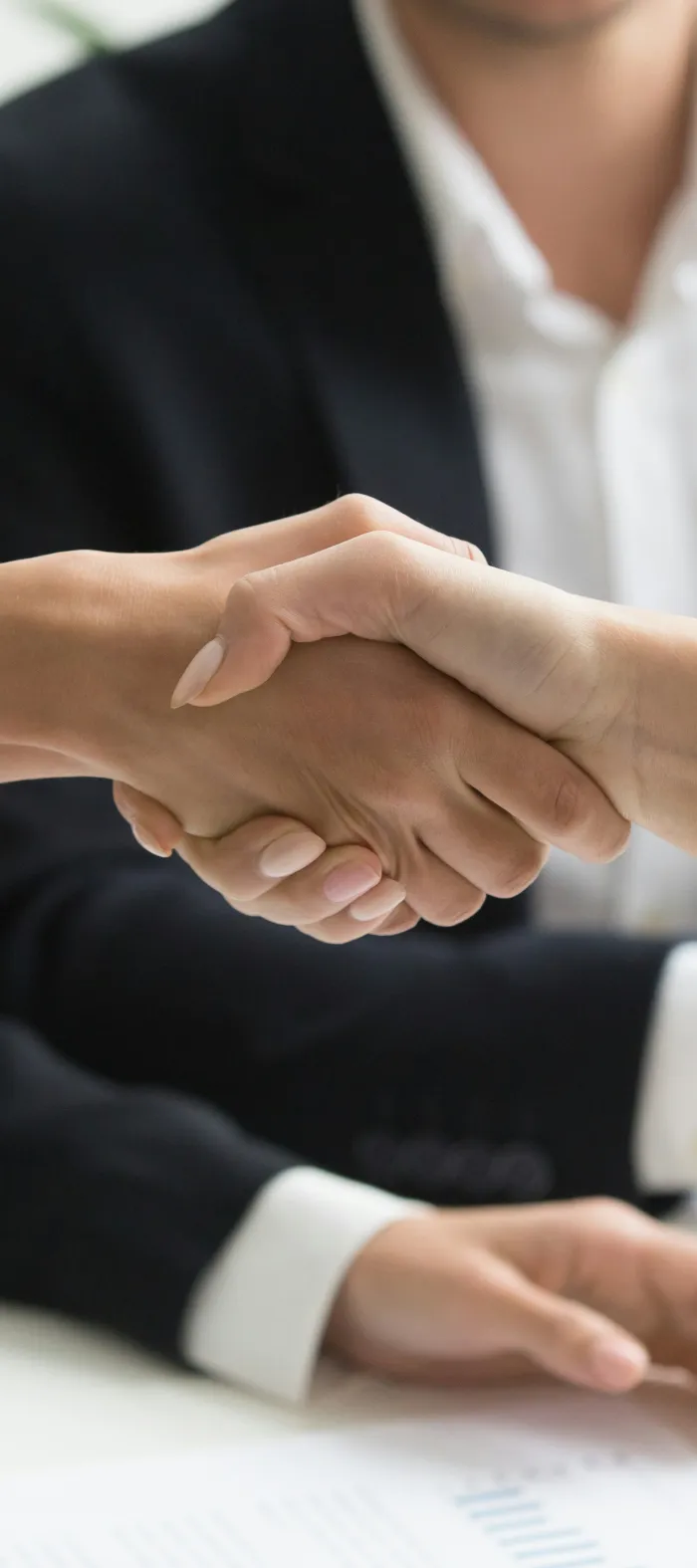 a close-up of people shaking hands