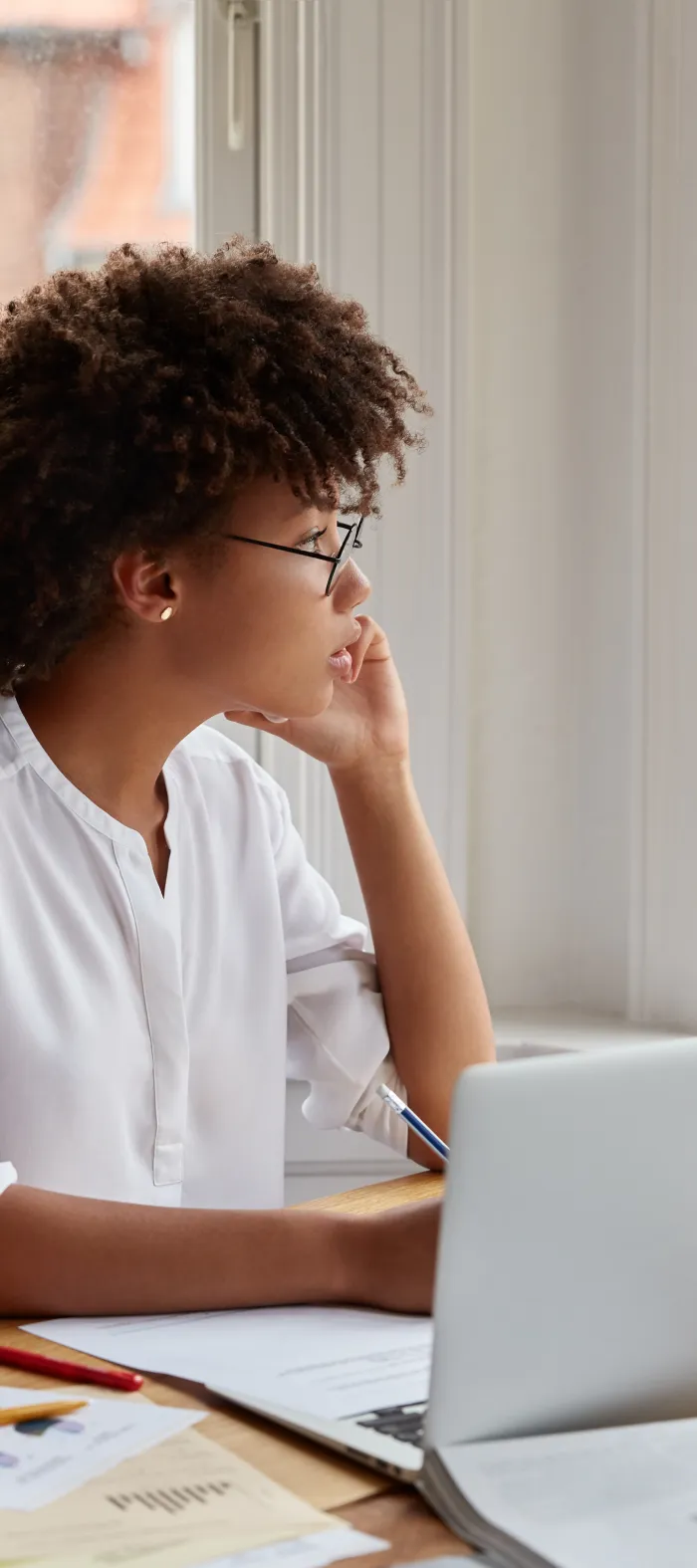 a person sitting at a table with a laptop