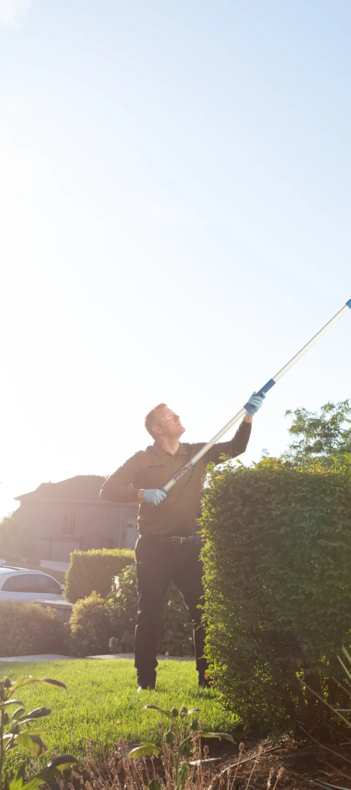 a Ridd technician holding a pest control sprayer