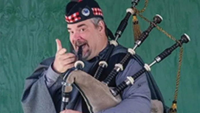 a man holding a microphone and pointing