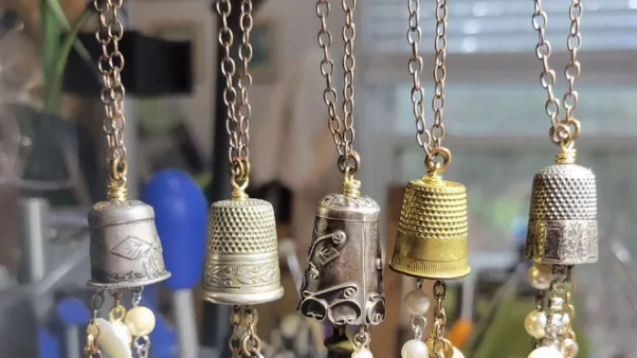 a group of gold and silver necklaces