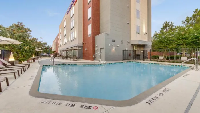 a swimming pool in front of a building