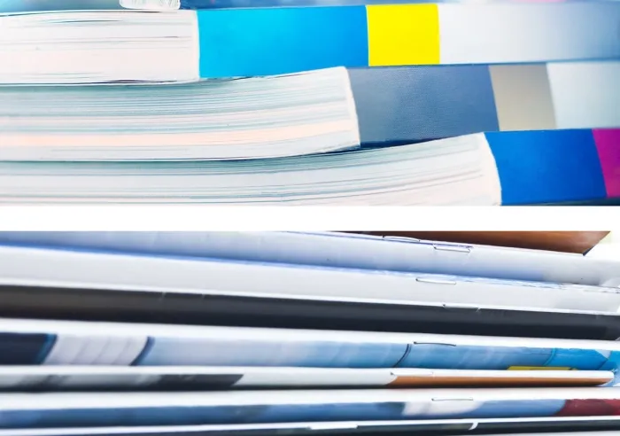A stack of Perfect Bound books and a stack of Saddle Stitched books