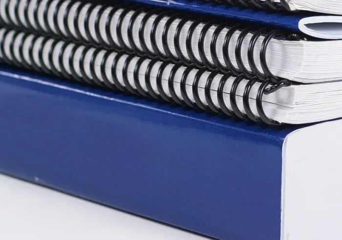 A variety of softcover books aligned in a stack