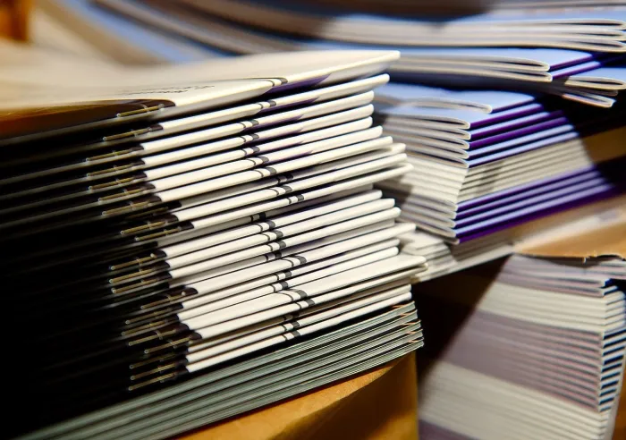 Stacks of printed brochures and booklets